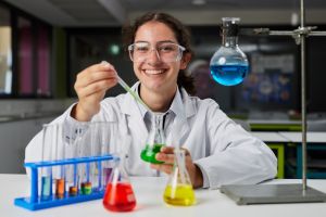 A photo showing a student in a science lab performing an experiment