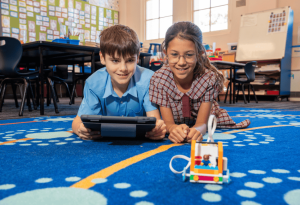 A photo showing two Sydney Catholic Schools students exploring STEM through coding and robotics.